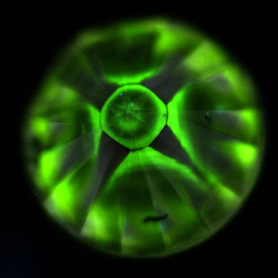 There are typical inclusions in this yellow HPHT-grown diamond.